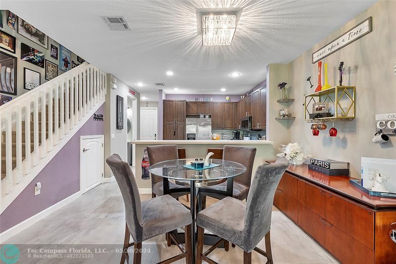 7774 Paddock Place, Unit 7774 Davie, FL 33328 - Photo 11 of 28 a dining room with furniture and a chandelier