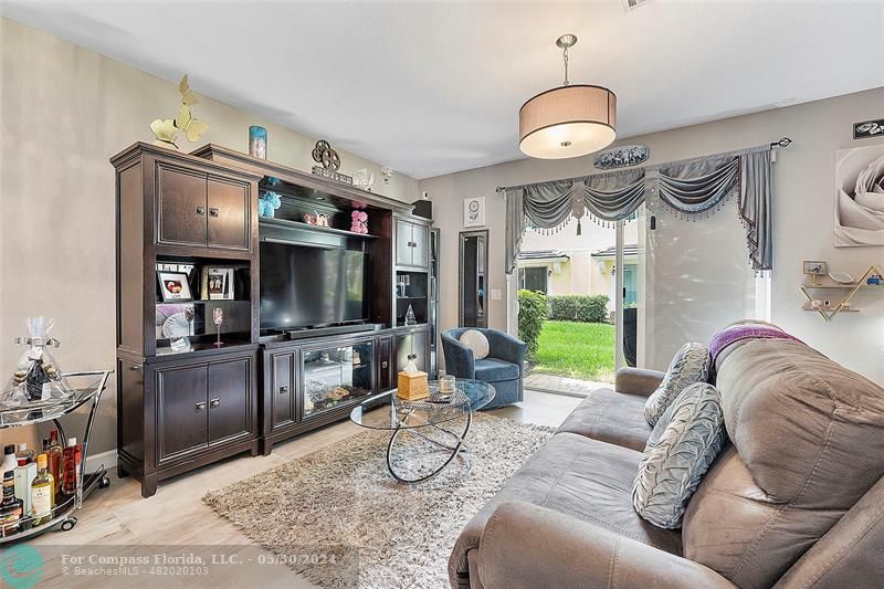 7774 Paddock Place, Unit 7774 Davie, FL 33328 - Photo 12 of 28 a living room with fireplace furniture and a flat screen tv