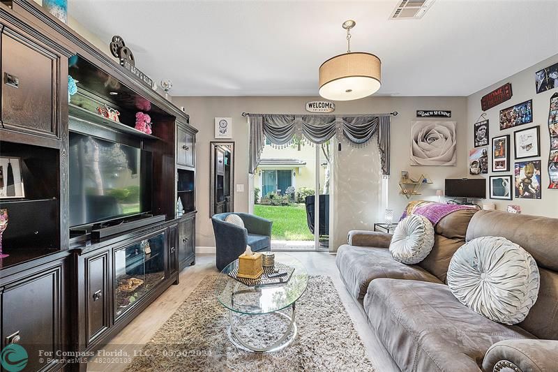 7774 Paddock Place, Unit 7774 Davie, FL 33328 - Photo 13 of 28 a living room with furniture a rug and a flat screen tv