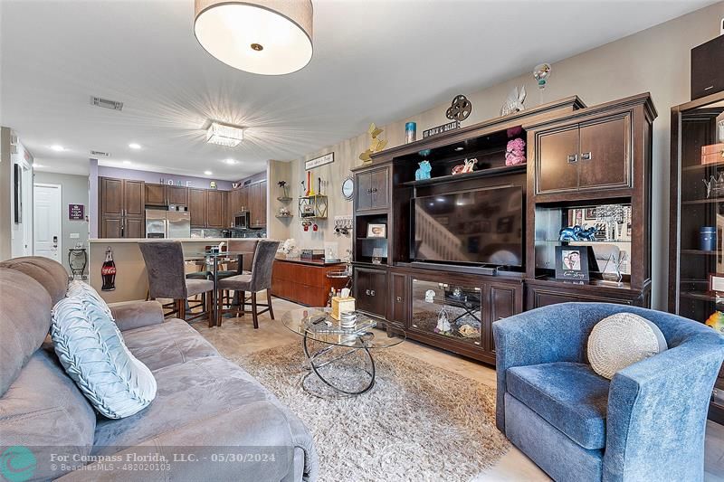 7774 Paddock Place, Unit 7774 Davie, FL 33328 - Photo 14 of 28 a living room with furniture and a flat screen tv