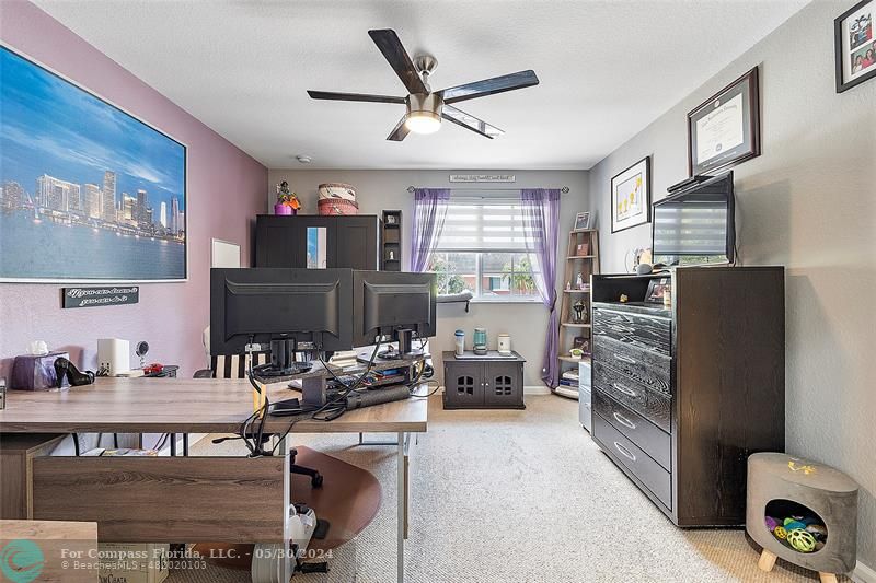 7774 Paddock Place, Unit 7774 Davie, FL 33328 - Photo 22 of 28 a work room with furniture large window and flat screen tv