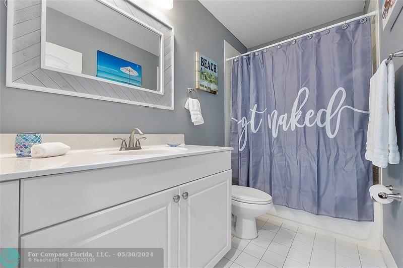 7774 Paddock Place, Unit 7774 Davie, FL 33328 - Photo 23 of 28 a bathroom with a sink a toilet and shower curtain