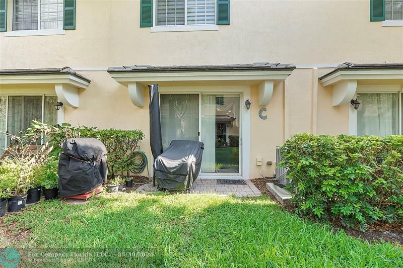 7774 Paddock Place, Unit 7774 Davie, FL 33328 - Photo 25 of 28 front view of house with a yard chairs and table in it