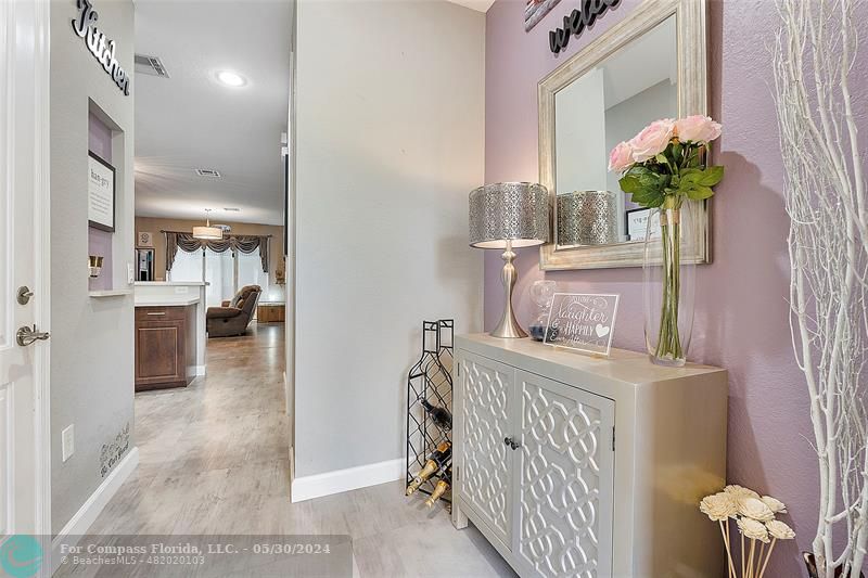 7774 Paddock Place, Unit 7774 Davie, FL 33328 - Photo 5 of 28 a view of a hallway to a livingroom with furniture and a chandelier