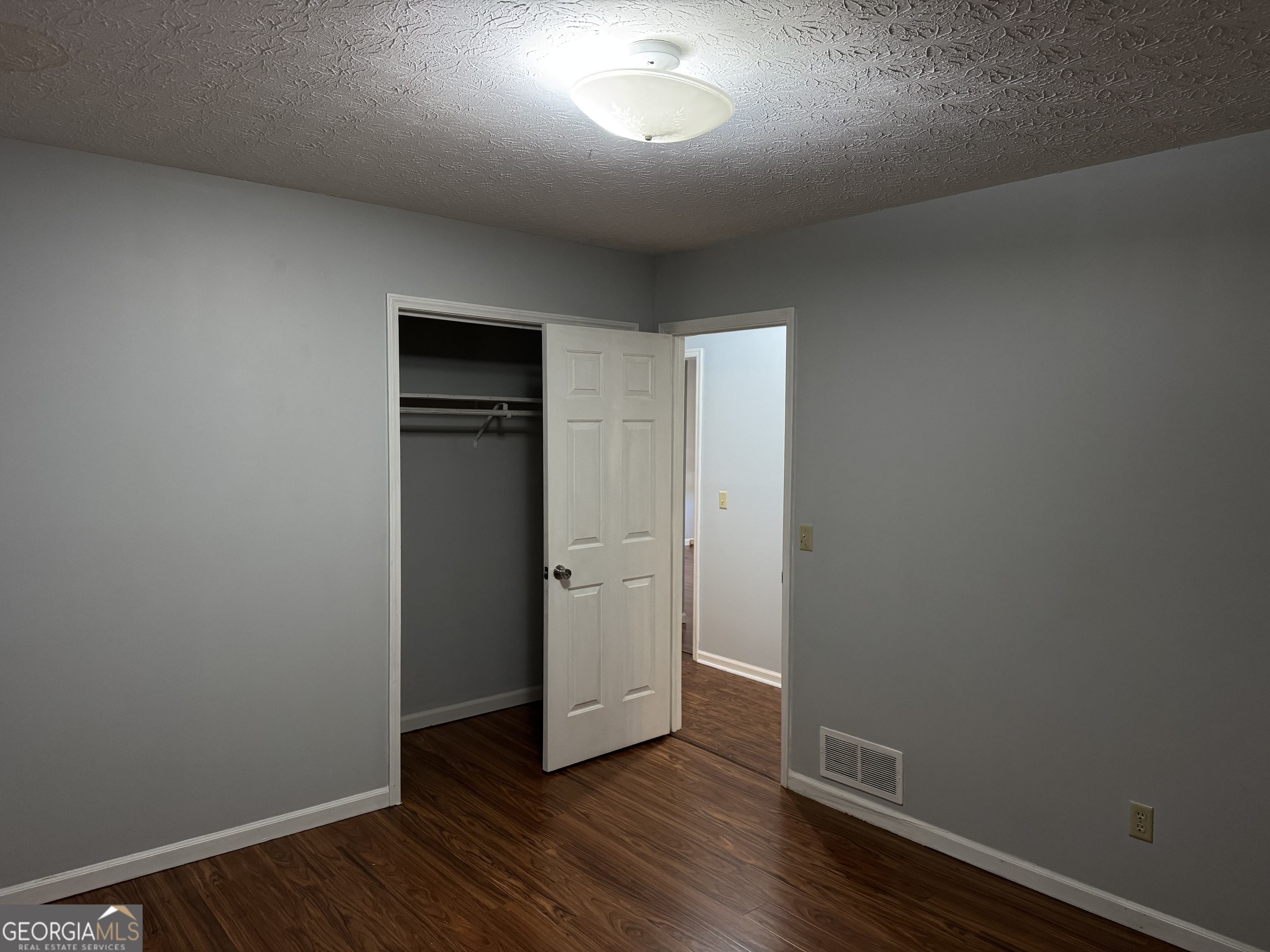 4055 Golfview Drive Villa Rica, GA 30180 - Photo 11 of 28 an empty room with wooden floor and closet