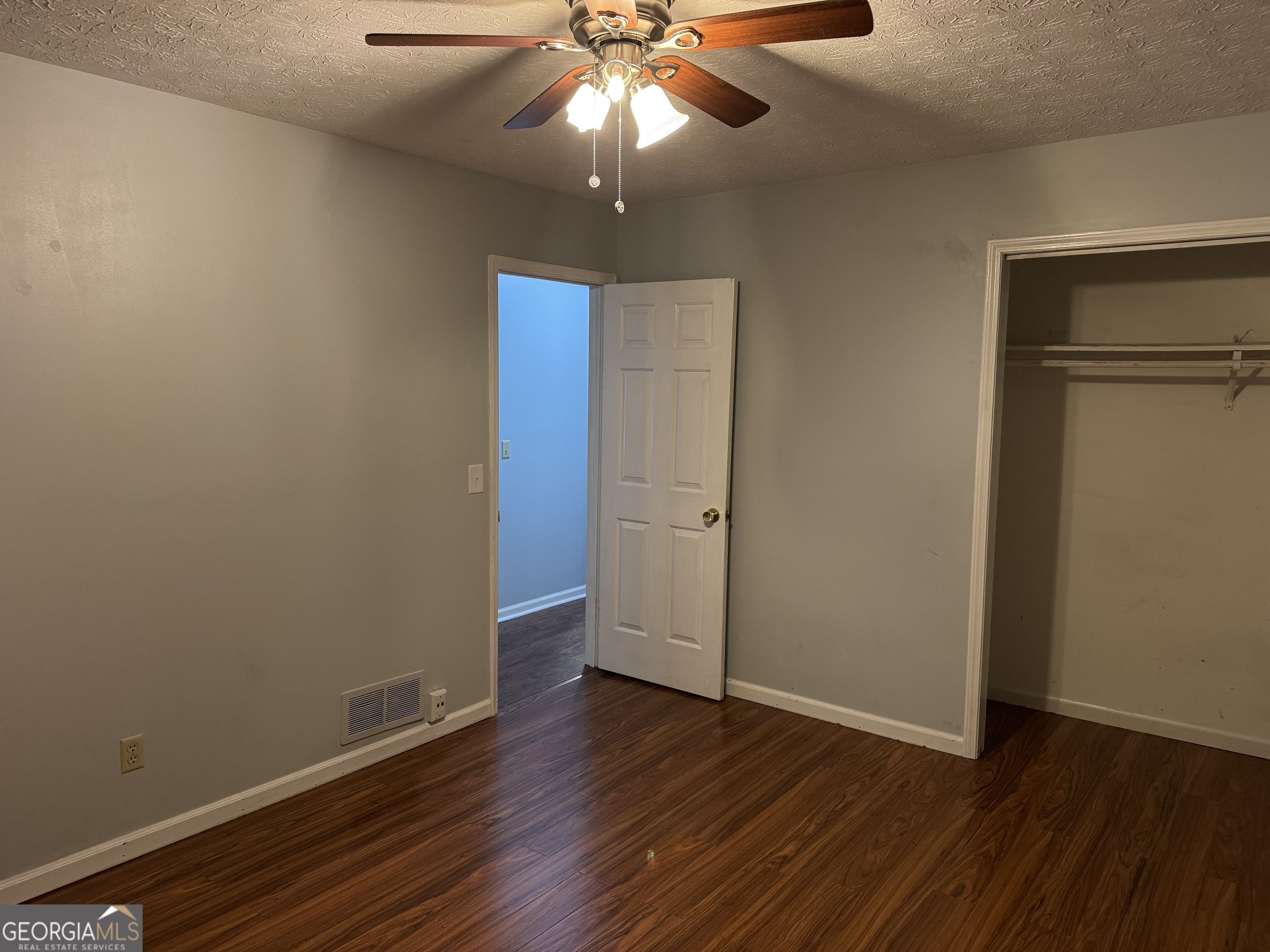 4055 Golfview Drive Villa Rica, GA 30180 - Photo 12 of 28 a view of an empty room with wooden floor and a ceiling fan