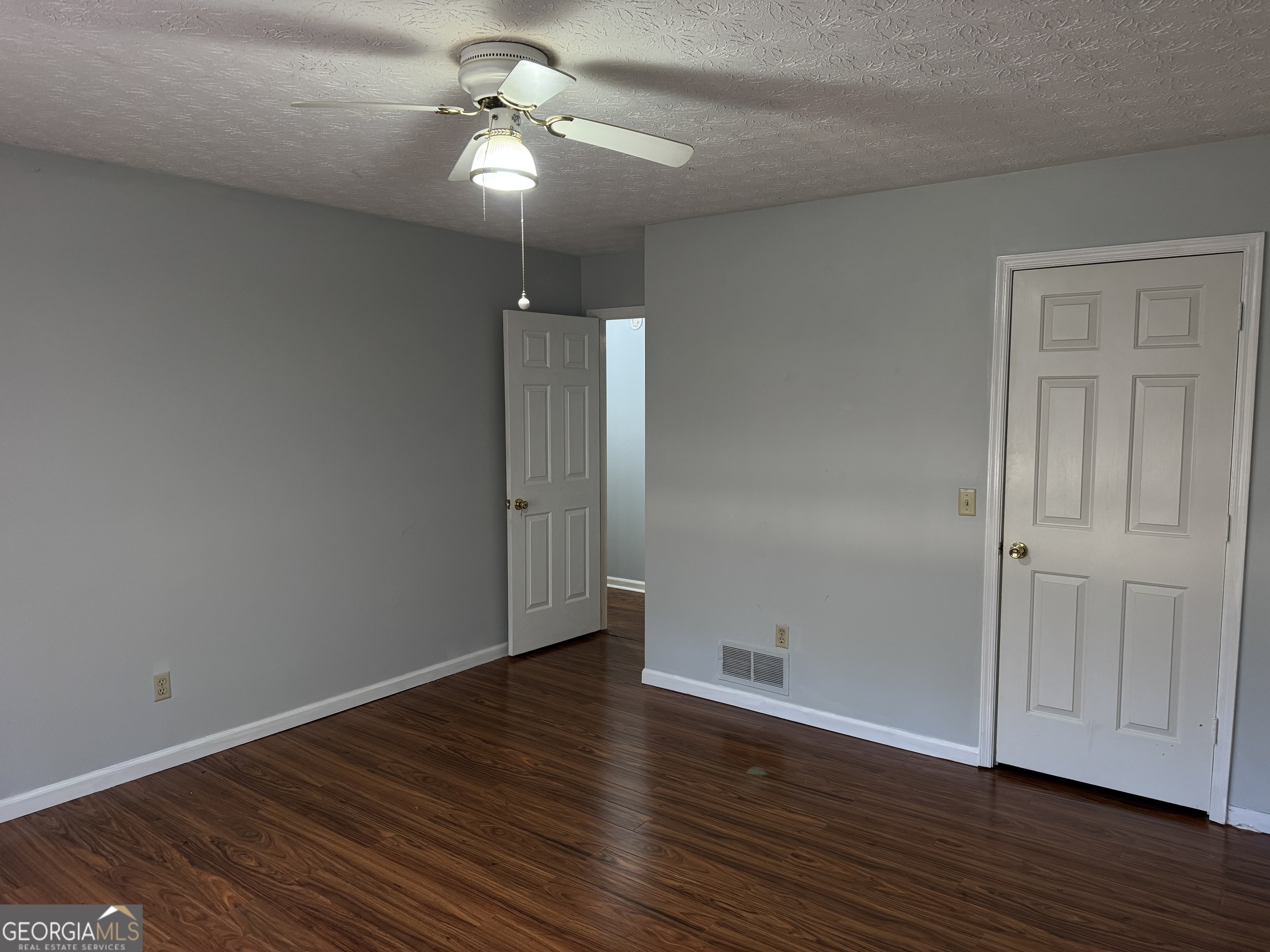 4055 Golfview Drive Villa Rica, GA 30180 - Photo 13 of 28 a view of an empty room with wooden floor fan and a window