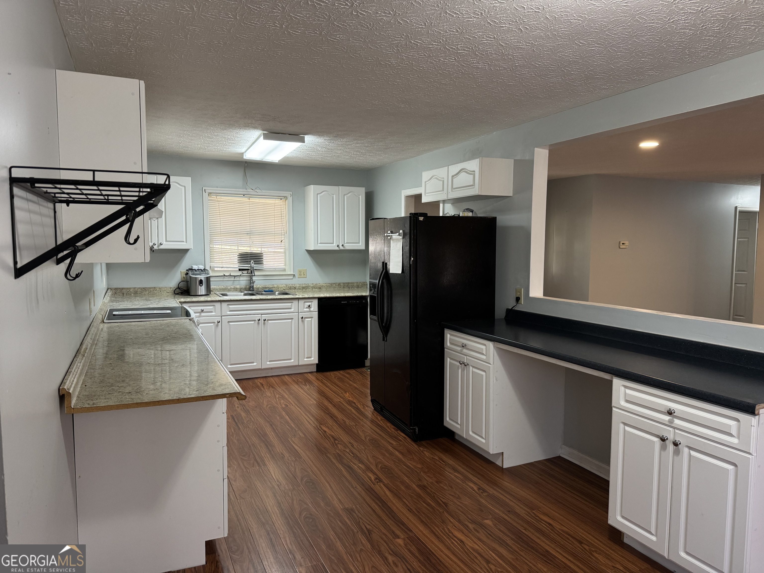 4055 Golfview Drive Villa Rica, GA 30180 - Photo 7 of 28 a kitchen with a sink a refrigerator and cabinets