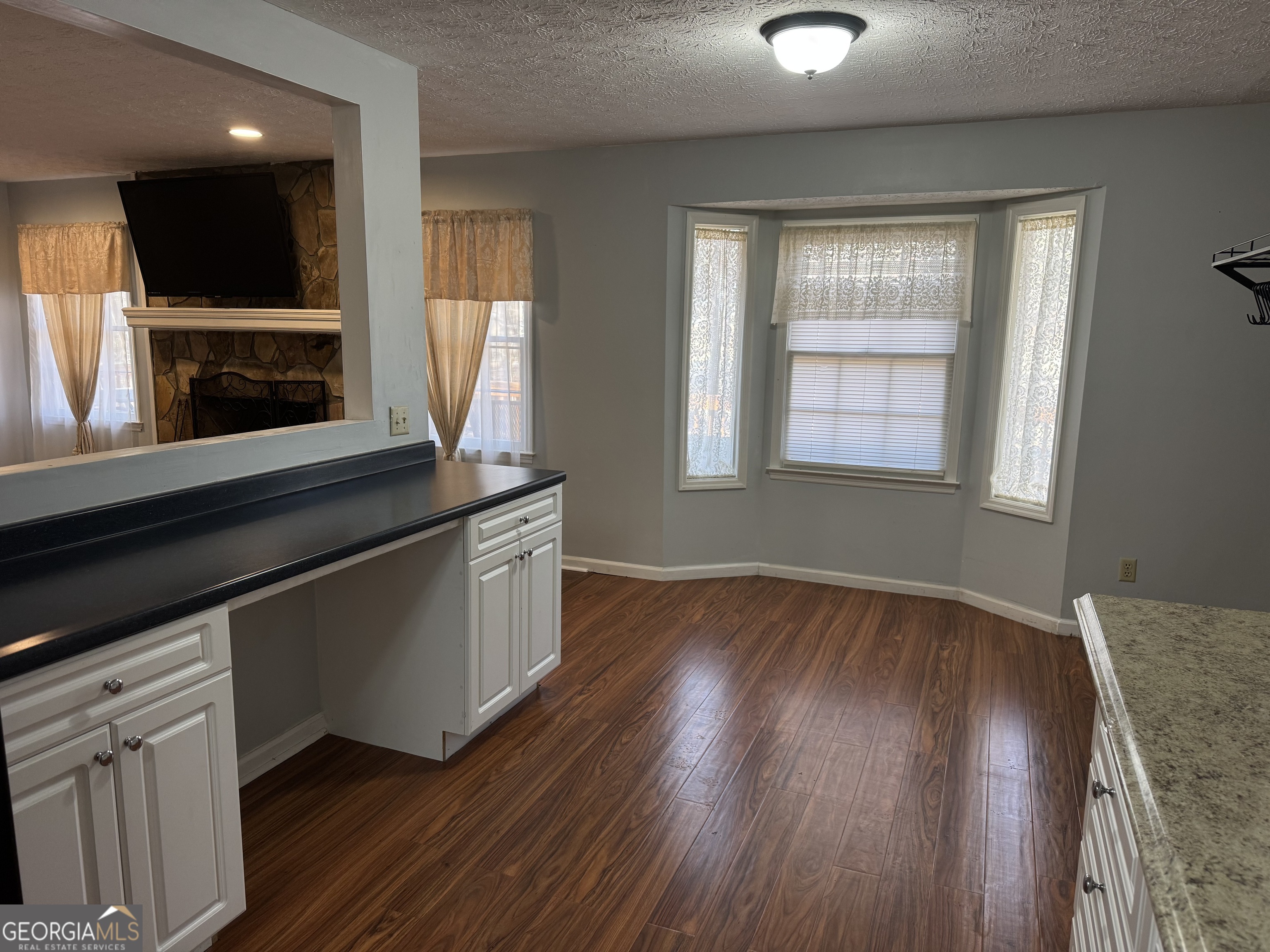 4055 Golfview Drive Villa Rica, GA 30180 - Photo 8 of 28 an empty room with wooden floor cabinet and windows