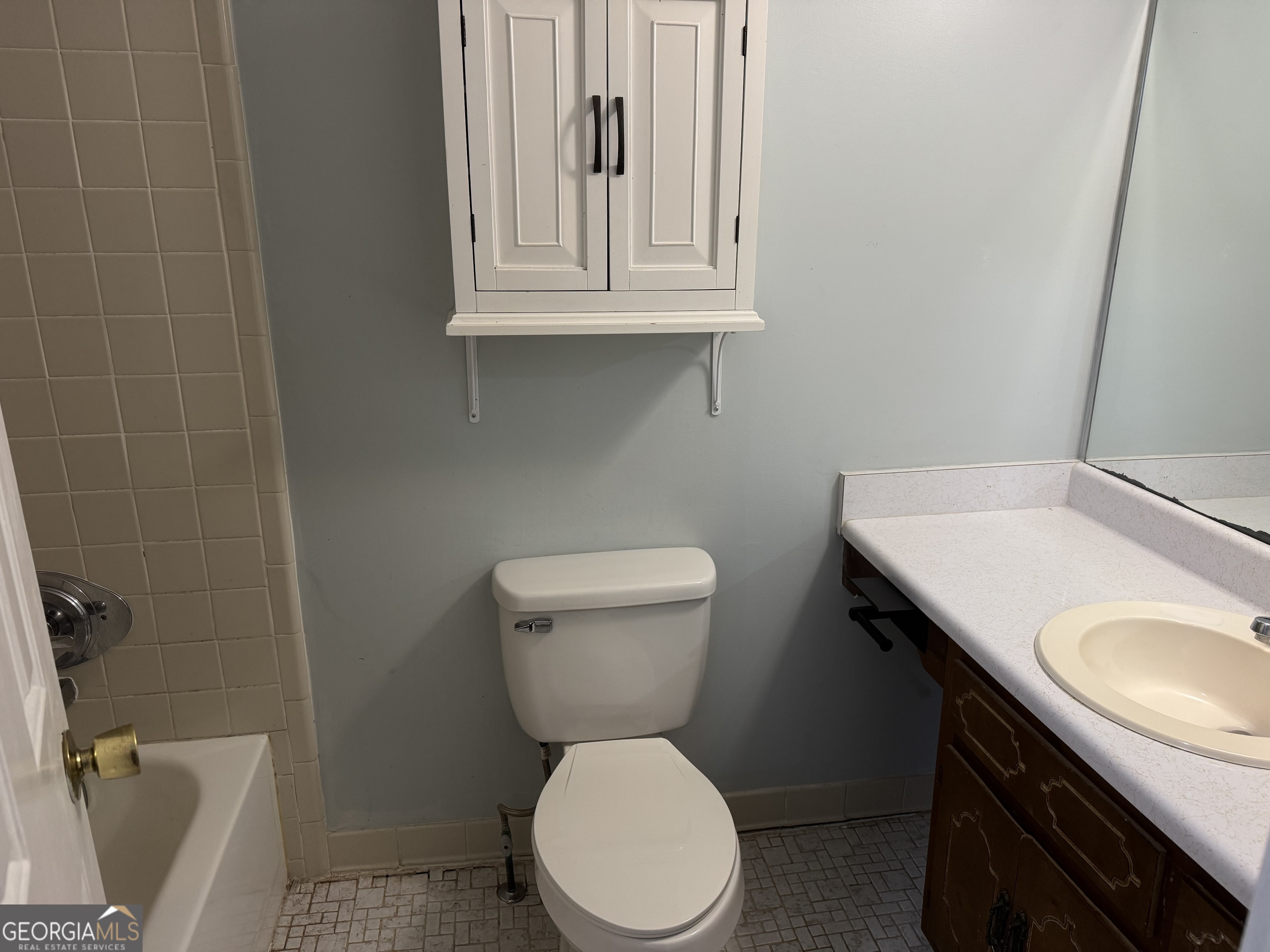 4055 Golfview Drive Villa Rica, GA 30180 - Photo 10 of 28 a bathroom with a sink a toilet and a mirror