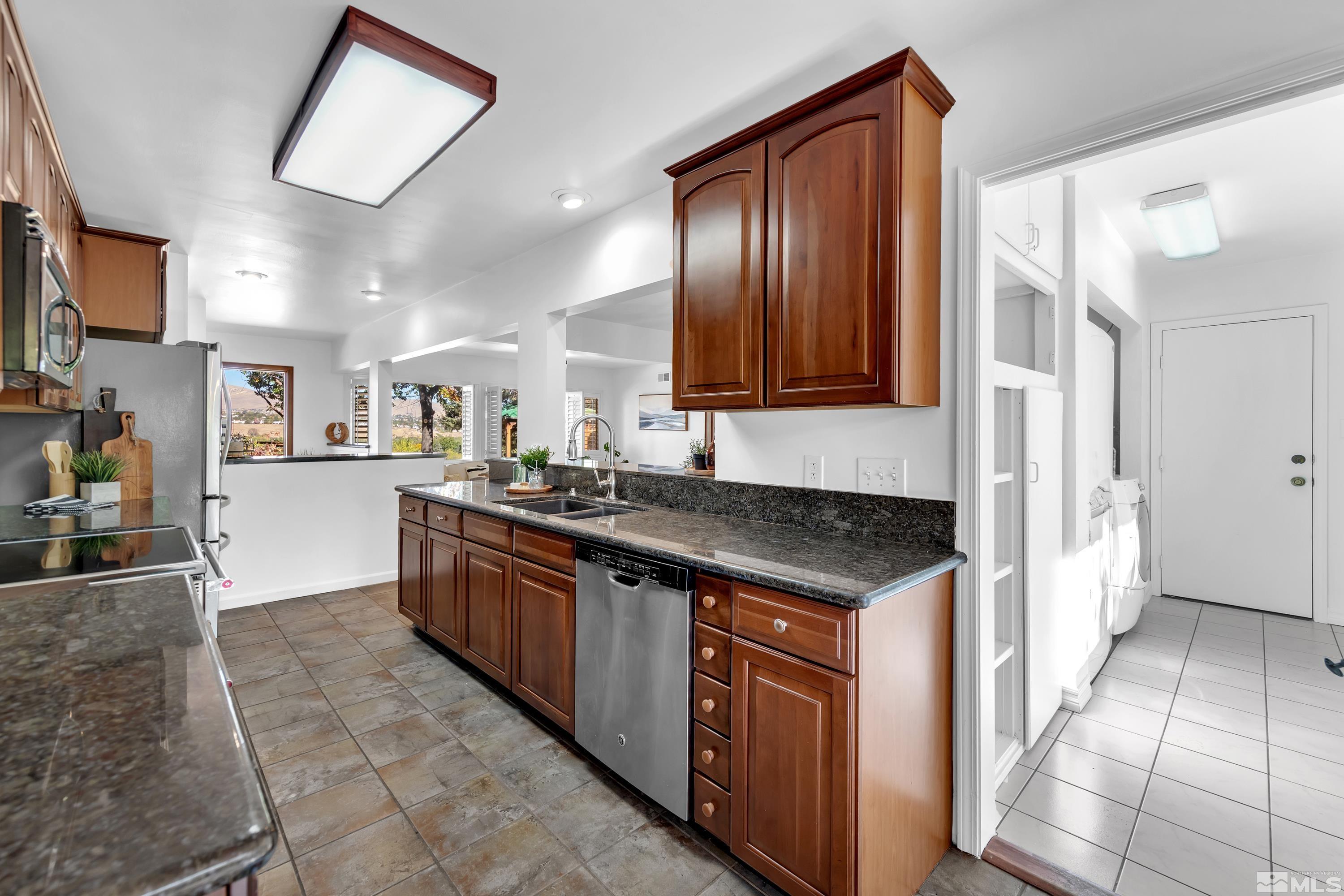 3075 West Plumb Lane Reno, NV 89509 - Photo 8 of 40 a kitchen with stainless steel appliances granite countertop a stove and a sink
