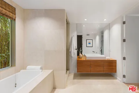 a bathroom with a bathtub and a shower