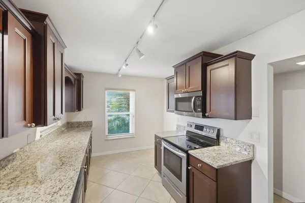 a kitchen that has a sink and a stove in it