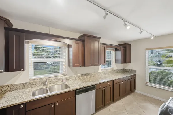 a kitchen with granite countertop a sink and a window