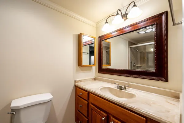 a bathroom with a toilet sink and mirror