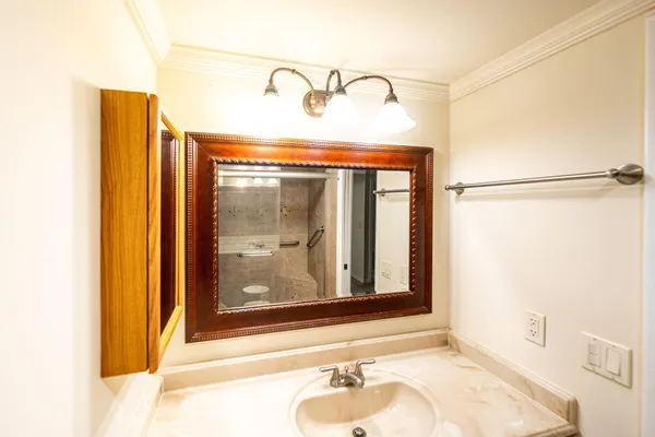 a bathroom with a sink and mirror