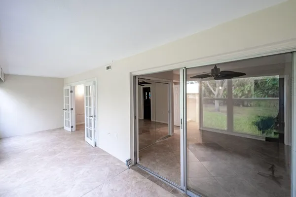 en empty room with sliding glass door and mountain view