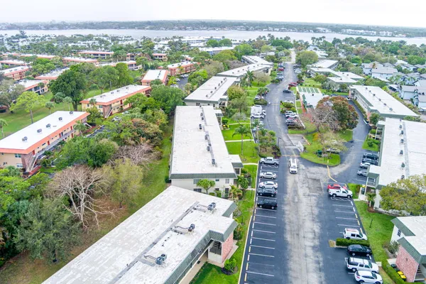an aerial view of a house with a garden and lake view