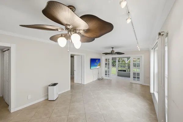 a view of a livingroom with furniture and chandelier fan