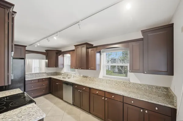 a kitchen with a sink stove and cabinets