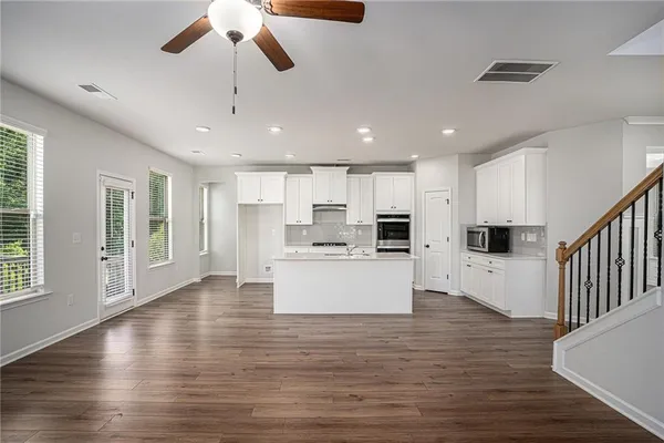 a view of kitchen with stainless steel appliances refrigerator oven and microwave