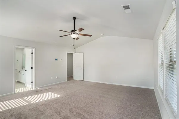 a view of a livingroom with a ceiling fan and window