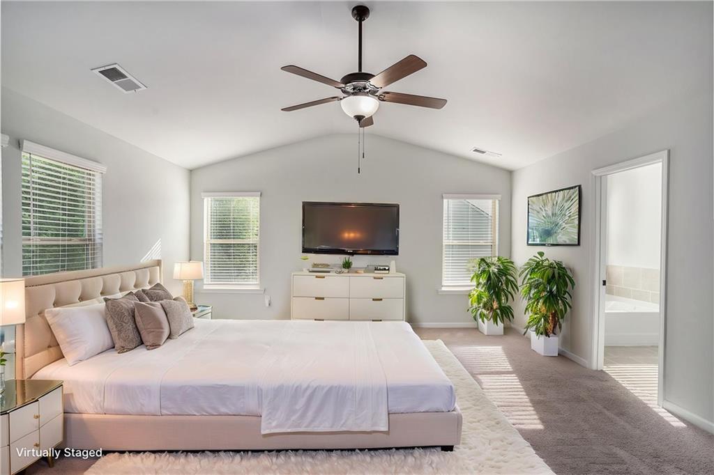 953 Mystic Way Hampton, GA 30228 - Photo 23 of 51 a bedroom with a bed and a flat screen tv