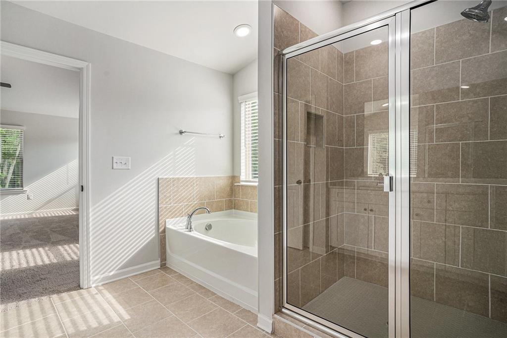 953 Mystic Way Hampton, GA 30228 - Photo 25 of 51 a bathroom with a bathtub and a shower