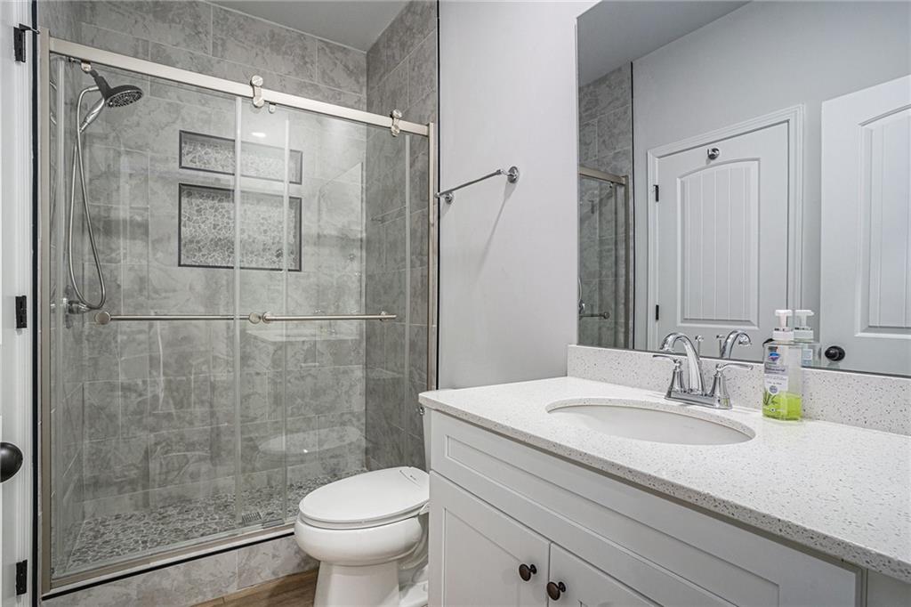 953 Mystic Way Hampton, GA 30228 - Photo 31 of 51 a bathroom with a granite countertop sink a toilet and shower