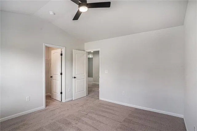 an empty room with closet and windows