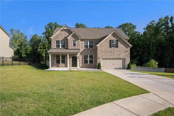 a front view of a house with a yard