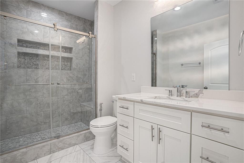953 Mystic Way Hampton, GA 30228 - Photo 41 of 51 a bathroom with a granite countertop sink toilet and shower