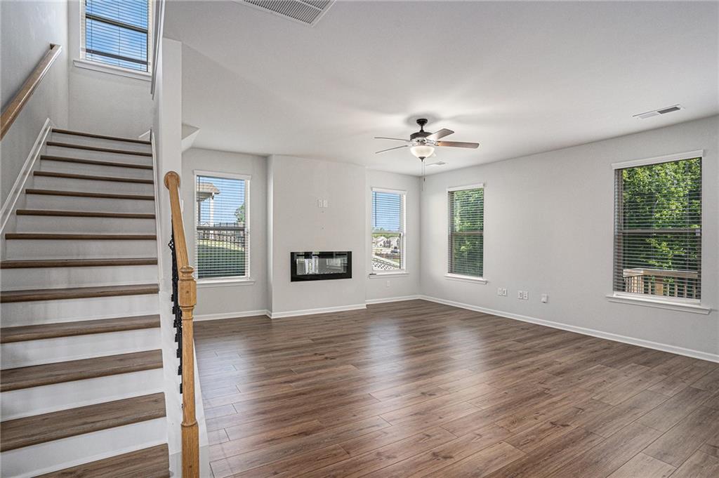 953 Mystic Way Hampton, GA 30228 - Photo 8 of 51 a view of an empty room with wooden floor and a window