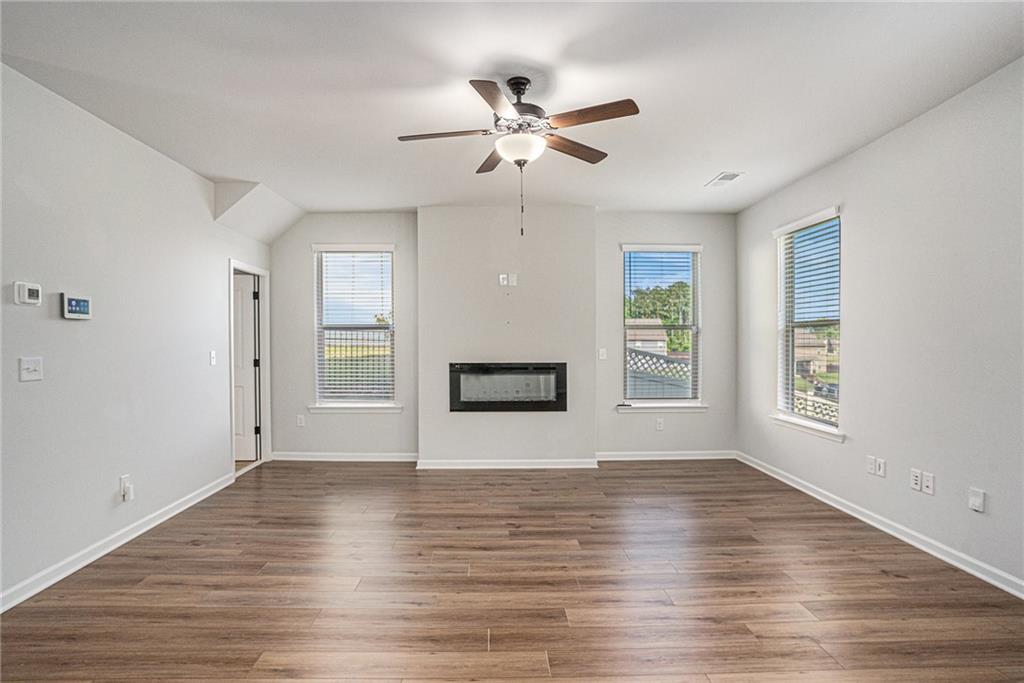 953 Mystic Way Hampton, GA 30228 - Photo 9 of 51 a view of an empty room with wooden floor and a window