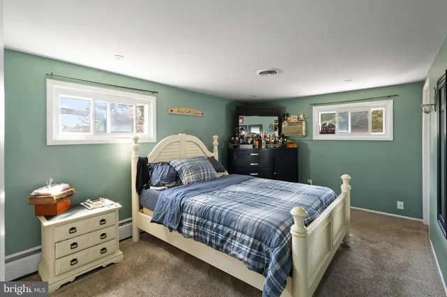 a bedroom with a bed and a dresser