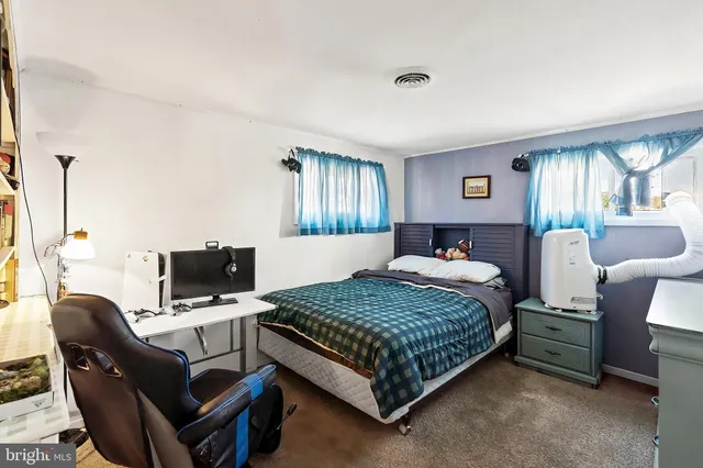a bedroom with a bed and a desk