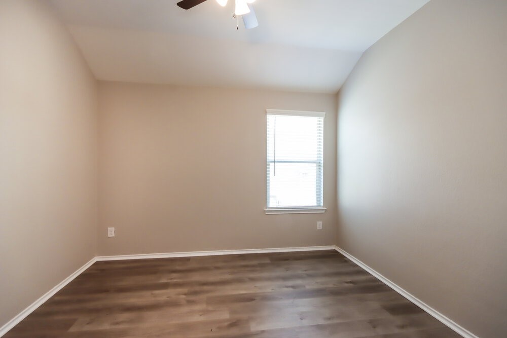 18378 Timbermill Lane New Caney, TX 77357 - Photo 11 of 16 an empty room with wooden floor and windows