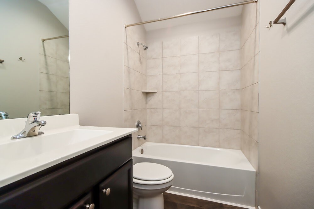 18378 Timbermill Lane New Caney, TX 77357 - Photo 15 of 16 a bathroom with a sink a toilet and a bathtub