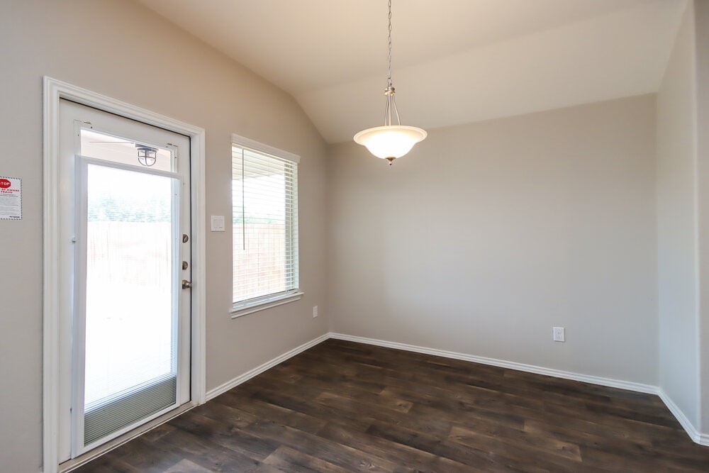 18378 Timbermill Lane New Caney, TX 77357 - Photo 4 of 16 an empty room with wooden floor and windows