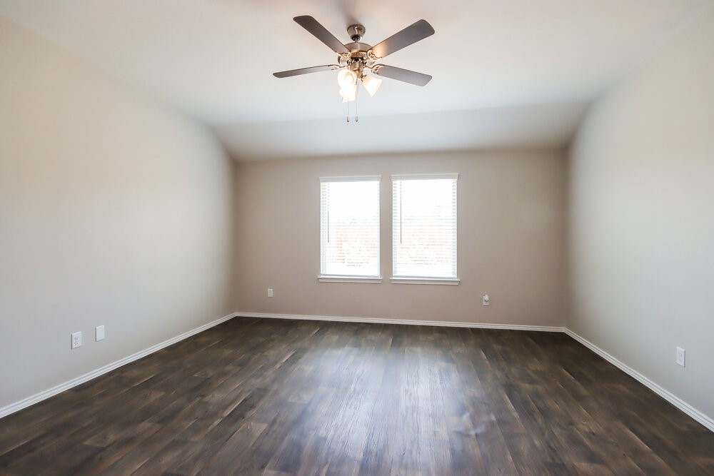 18378 Timbermill Lane New Caney, TX 77357 - Photo 7 of 16 an empty room with wooden floor and windows