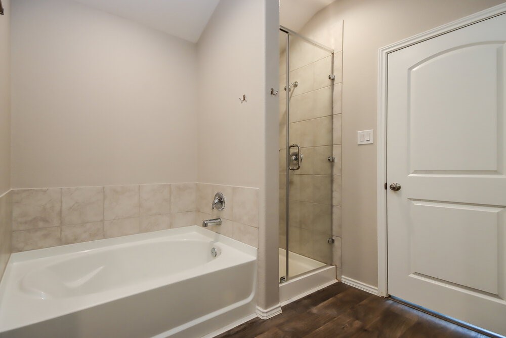 18378 Timbermill Lane New Caney, TX 77357 - Photo 10 of 16 a bathroom with a bathtub and a shower