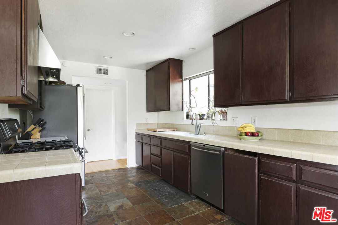 1926 Corral Canyon Road Malibu, CA 90265 - Photo 12 of 29 a kitchen with stainless steel appliances a sink stove and refrigerator