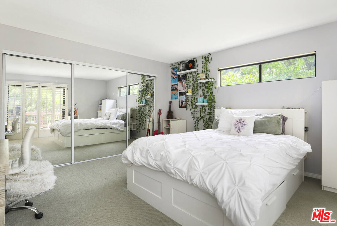 1926 Corral Canyon Road Malibu, CA 90265 - Photo 17 of 29 a bedroom with a large bed and a view of living room