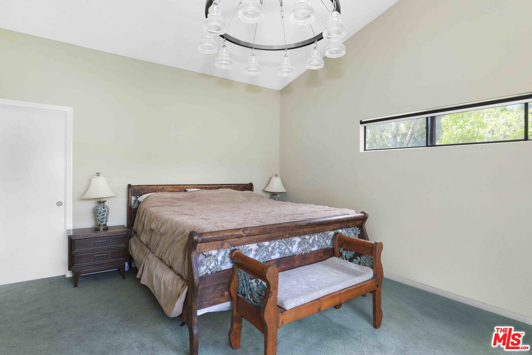 1926 Corral Canyon Road Malibu, CA 90265 - Photo 19 of 29 a bedroom with a bed and a chandelier