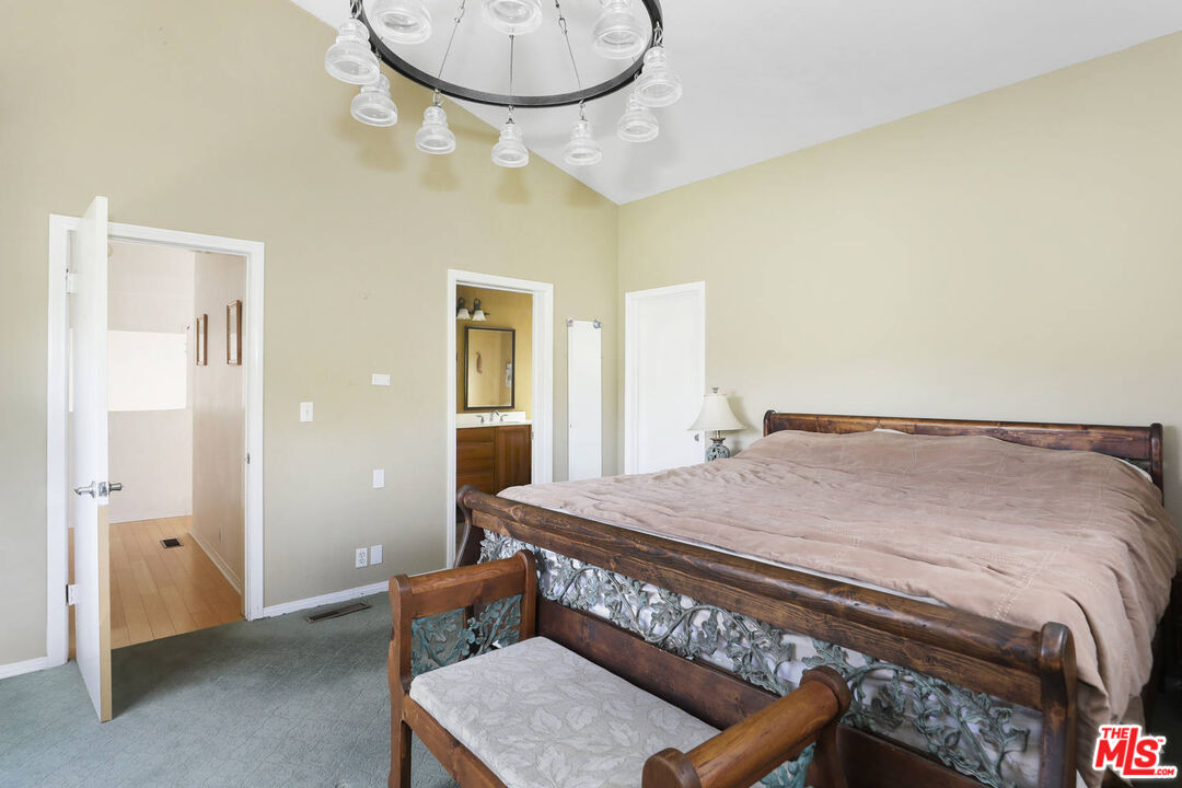 1926 Corral Canyon Road Malibu, CA 90265 - Photo 20 of 29 a bedroom with a bed and a chandelier