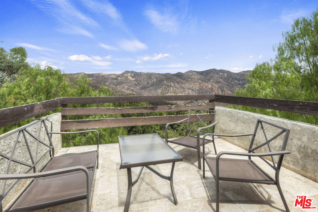1926 Corral Canyon Road Malibu, CA 90265 - Photo 24 of 29 a view of a chairs and table in the terrace
