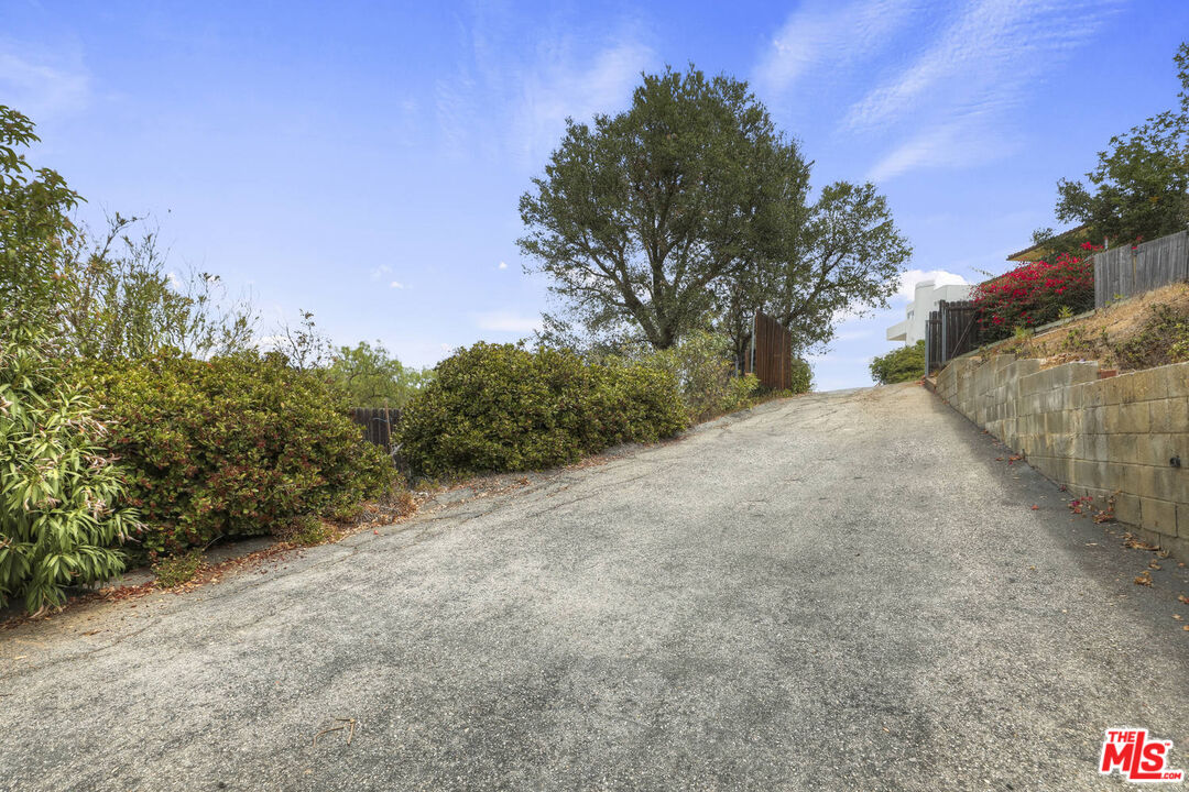 1926 Corral Canyon Road Malibu, CA 90265 - Photo 29 of 29 a view of a road with a trees in the background