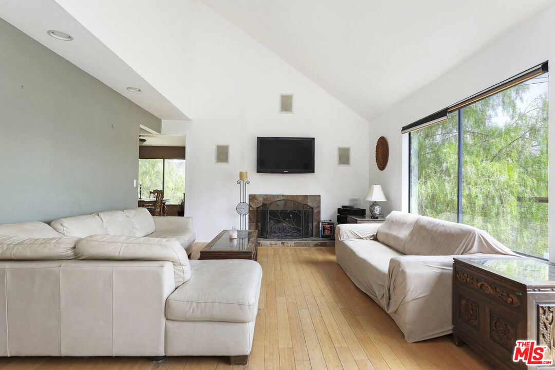 1926 Corral Canyon Road Malibu, CA 90265 - Photo 5 of 29 a living room with furniture a fireplace and a large window
