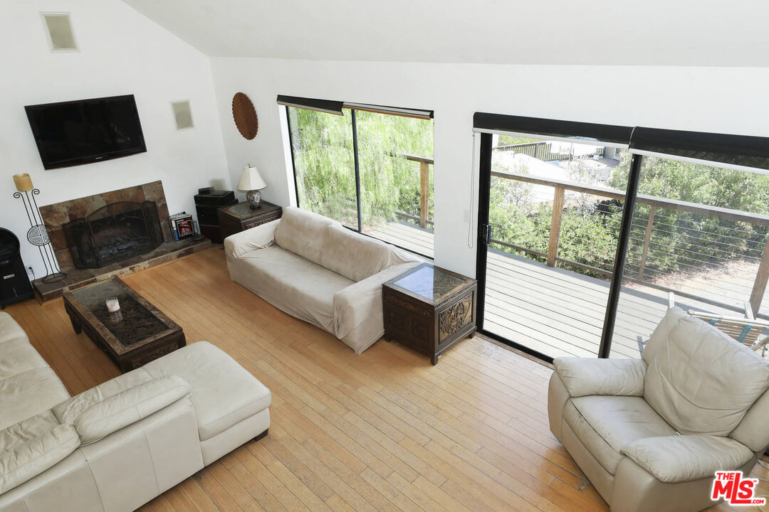 1926 Corral Canyon Road Malibu, CA 90265 - Photo 7 of 29 a living room with couches a flat screen tv and a large window