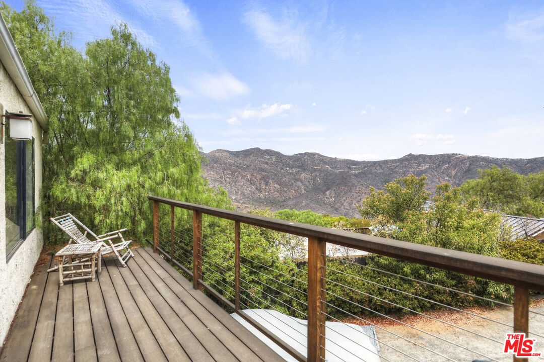 1926 Corral Canyon Road Malibu, CA 90265 - Photo 8 of 29 a view of a balcony with wooden floor and fence